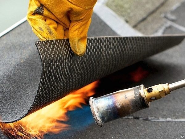 Foto: Gerollte Abdichtung wird durch einen Brenner beheizt