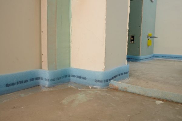 The tape is laid around the perimeter of the room