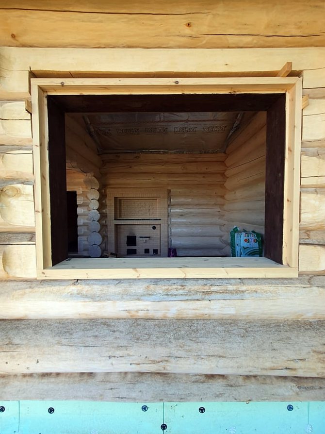 Installation d'encadrement de fenêtres dans une maison en bois, écart supérieur