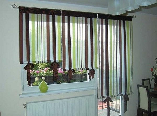 stores romains sur une fenêtre avec une porte de balcon